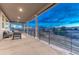 Covered patio with comfortable seating and a view of the surrounding landscape at 2957 Eagle Wing Way, Castle Rock, CO 80109