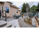 Serene backyard with a patio, dining area, lush landscaping, and decorative elements creating a peaceful outdoor oasis at 1913 Five Iron Dr, Castle Rock, CO 80104