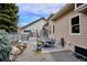 Spacious backyard showcasing a patio with dining set, outdoor kitchen, landscaped garden beds, and a tranquil setting at 1913 Five Iron Dr, Castle Rock, CO 80104