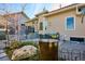 Well-maintained backyard featuring a patio with outdoor dining, decorative fountain, and beautifully landscaped garden beds at 1913 Five Iron Dr, Castle Rock, CO 80104