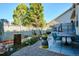 Charming backyard featuring a patio with dining set, manicured garden beds, decorative elements, and a privacy fence at 1913 Five Iron Dr, Castle Rock, CO 80104