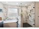 Luxurious bathroom featuring marble accents, a soaking tub, and a modern glass shower enclosure at 1913 Five Iron Dr, Castle Rock, CO 80104