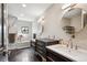 Elegant bathroom featuring double sinks, designer fixtures, and a marble accent wall at 1913 Five Iron Dr, Castle Rock, CO 80104