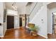 Elegant foyer featuring hardwood floors, a staircase with white railings, and modern lighting fixtures at 1913 Five Iron Dr, Castle Rock, CO 80104