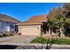Inviting single-story home with a two-car garage, mature tree, and manicured front lawn at 1913 Five Iron Dr, Castle Rock, CO 80104