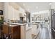 Bright, updated kitchen with white cabinets, stainless steel appliances, and a unique backsplash at 1913 Five Iron Dr, Castle Rock, CO 80104