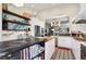 Spacious kitchen with a large island, stainless appliances, and open shelving with custom backsplash at 1913 Five Iron Dr, Castle Rock, CO 80104
