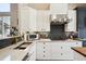 Stylish kitchen with stainless steel appliances, white cabinets, and a contrasting dark backsplash at 1913 Five Iron Dr, Castle Rock, CO 80104