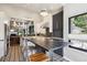 Modern kitchen with an eat-in island, pendant lighting, and views into other parts of the home at 1913 Five Iron Dr, Castle Rock, CO 80104