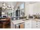 Open-concept kitchen showcasing a stainless dishwasher, white cabinets, and a view into the dining room at 1913 Five Iron Dr, Castle Rock, CO 80104