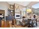 Cozy living room with a fireplace, built-in bookshelves, and comfortable seating, perfect for relaxation at 1913 Five Iron Dr, Castle Rock, CO 80104