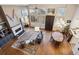 Bright living room featuring a fireplace, hardwood floors, and large windows providing ample natural light at 1913 Five Iron Dr, Castle Rock, CO 80104