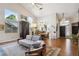 Open-concept living area with hardwood floors, large windows, and stylish lighting fixtures creating a modern aesthetic at 1913 Five Iron Dr, Castle Rock, CO 80104