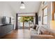 Comfortable living room featuring hardwood floors, a sliding glass door, and a modern media center at 1913 Five Iron Dr, Castle Rock, CO 80104
