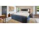 Serene main bedroom with a plush upholstered bed, soft lighting, and a calming color palette at 1913 Five Iron Dr, Castle Rock, CO 80104