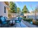 Inviting patio area with a dining table and seating, surrounded by lush greenery and a decorative fence for privacy at 1913 Five Iron Dr, Castle Rock, CO 80104