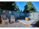 Cozy backyard seating area with comfortable chairs and bench, perfect for relaxing and entertaining guests in a serene setting at 1913 Five Iron Dr, Castle Rock, CO 80104