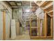 Utility area featuring a water heater, exposed pipes, and a staircase leading to the upper level at 2838 S Heather Gardens Way # A, Aurora, CO 80014