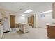 Finished basement with tile flooring, center island with drawers, and laundry area with washer and dryer at 2838 S Heather Gardens Way # A, Aurora, CO 80014