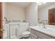 Bathroom features a walk-in bathtub and a white vanity at 2838 S Heather Gardens Way # A, Aurora, CO 80014