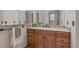 Bathroom vanity featuring granite counters and wood cabinets at 2838 S Heather Gardens Way # A, Aurora, CO 80014