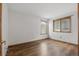 Bedroom with wood floors, white walls, and natural light at 2838 S Heather Gardens Way # A, Aurora, CO 80014