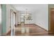 Bright dining room with hardwood floors and a view into the modern kitchen at 2838 S Heather Gardens Way # A, Aurora, CO 80014