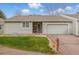 Charming single Gathering home featuring an attached garage and a well-manicured front lawn at 2838 S Heather Gardens Way # A, Aurora, CO 80014