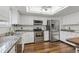 Modern kitchen featuring white cabinets, stainless steel appliances, and granite countertops at 2838 S Heather Gardens Way # A, Aurora, CO 80014