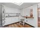 Bright kitchen with white cabinets, stainless steel refrigerator, and granite countertops at 2838 S Heather Gardens Way # A, Aurora, CO 80014