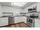 Modern kitchen featuring white cabinets, stainless steel appliances, and updated countertops at 2838 S Heather Gardens Way # A, Aurora, CO 80014