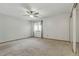 Spacious bedroom featuring neutral carpet, ceiling fan, and closet at 2838 S Heather Gardens Way # A, Aurora, CO 80014