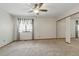 Spacious bedroom featuring neutral carpet, ceiling fan, and closet at 2838 S Heather Gardens Way # A, Aurora, CO 80014