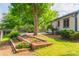 Inviting backyard features mature trees, lush landscaping, and raised flower beds for gardening enthusiasts at 1248 Ilium Dr, Lafayette, CO 80026