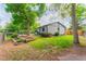 Landscaped backyard featuring mature shade trees, privacy fence, and garden area for peaceful outdoor living at 1248 Ilium Dr, Lafayette, CO 80026