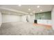 Spacious basement with a kitchenette area, featuring a wet bar, white cabinetry and modern backsplash at 1248 Ilium Dr, Lafayette, CO 80026