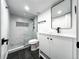 Modern bathroom featuring tiled walk-in shower, toilet, vanity, matte black accents, and square mirror at 1248 Ilium Dr, Lafayette, CO 80026