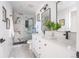 Modern bathroom featuring double sinks, sleek black fixtures, and a walk-in shower at 1248 Ilium Dr, Lafayette, CO 80026