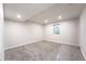 Bedroom with neutral carpet and walls, featuring a window and recessed lighting for a modern look at 1248 Ilium Dr, Lafayette, CO 80026