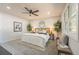 Relaxing primary bedroom with stylish decor, a ceiling fan, and a large window at 1248 Ilium Dr, Lafayette, CO 80026