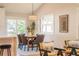 Cozy dining area features natural light, contemporary pendant and comfortable seating at 1248 Ilium Dr, Lafayette, CO 80026