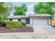 Charming single-story home with a two-car garage, complemented by lush landscaping and a well-maintained yard at 1248 Ilium Dr, Lafayette, CO 80026