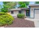A well-manicured front yard featuring fresh mulch and vibrant green bushes enhancing the home's curb appeal at 1248 Ilium Dr, Lafayette, CO 80026