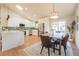 Contemporary kitchen featuring white cabinets, quartz countertops, and open access to the dining room at 1248 Ilium Dr, Lafayette, CO 80026
