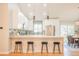 Modern kitchen with stainless steel appliances, counter seating, and open access to the dining area at 1248 Ilium Dr, Lafayette, CO 80026