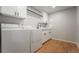 Laundry room featuring a washer, dryer, storage cabinets and a countertop with a faucet at 1248 Ilium Dr, Lafayette, CO 80026