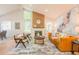 Bright and airy living room with a fireplace, skylights, a vaulted ceiling, and stylish furniture at 1248 Ilium Dr, Lafayette, CO 80026
