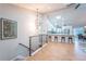 Inviting open-concept with light-wood floors, counter seating, and a modern chandelier over the stairwell at 1248 Ilium Dr, Lafayette, CO 80026