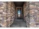 Inviting entryway with a stone archway and a decorative glass front door at 2627 Hillcroft Ln, Castle Rock, CO 80104