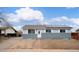 Charming single-story home with a well-maintained lawn and solar panels on the roof at 5411 Chandler Way, Denver, CO 80239